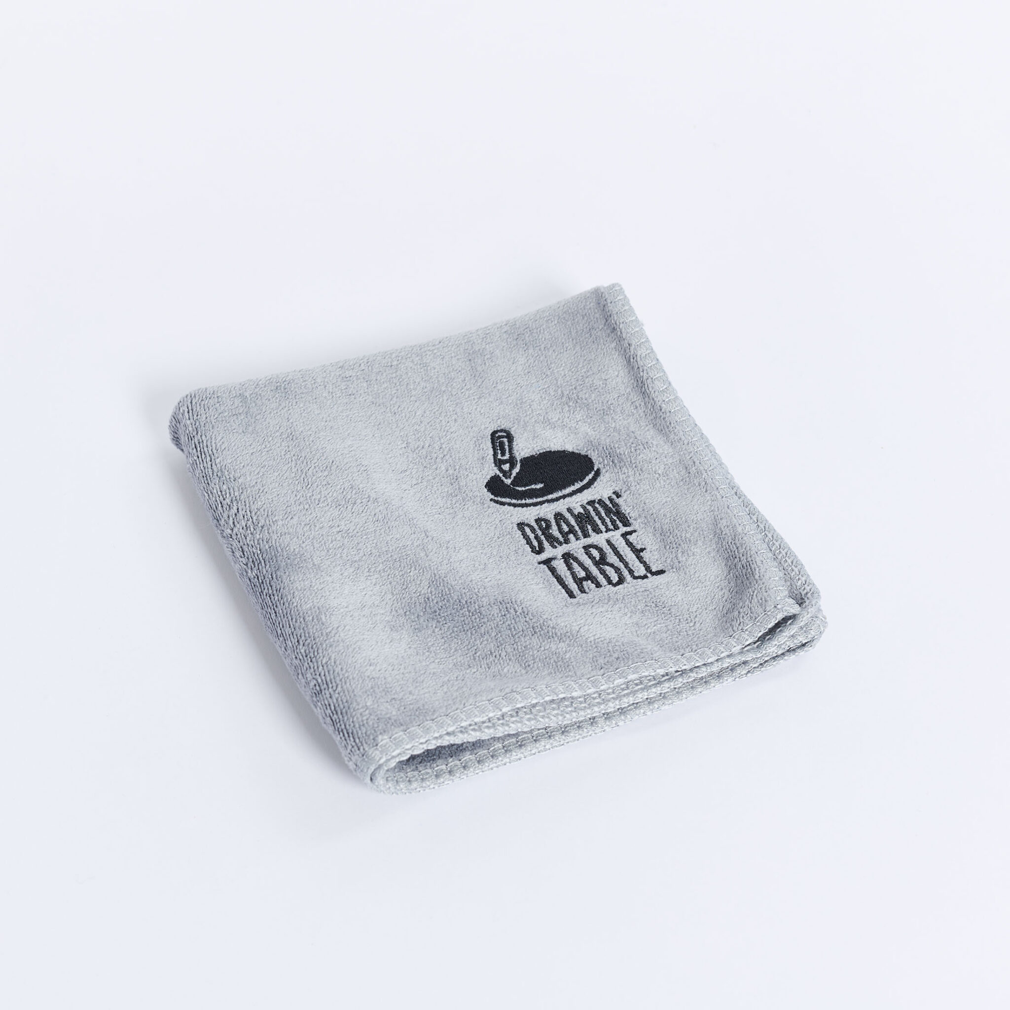 Grey cotton towel with embroidered text.